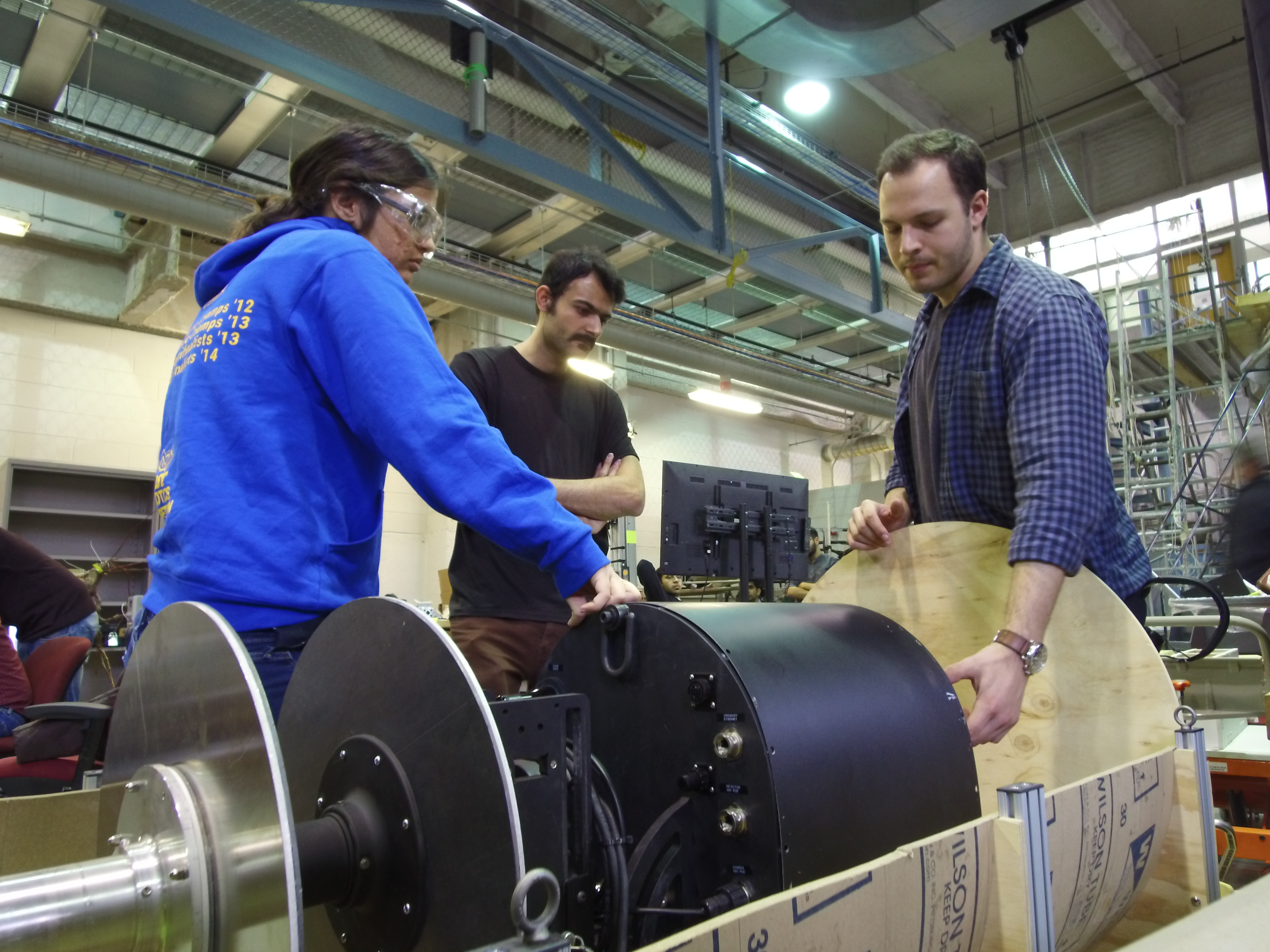 Photo of RadPiper trio shows L-R: Siri Maley (MechE masters student), Mohammad Mousaei (research associate), and Lawrence Papincak, (MechE master’s student).